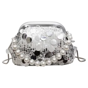 Silver sequin kiss-lock evening bag with elegant pearl handle and chain strap for women.