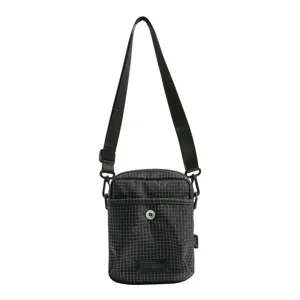 Detailed view of the black grid shoulder crossbody bag showing adjustable strap and front pocket.