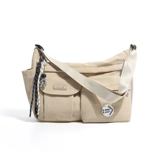 Casual nylon messenger bag with multi pockets and astronaut pendant for daily use.