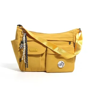 Casual yellow nylon messenger bag for students, multiple pockets, crossbody strap, daily use.