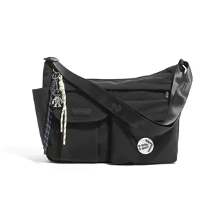 Black nylon messenger bag detailed view featuring durable fabric, multiple pockets and charm.