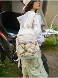 Detail view of the color-blocked casual backpack featuring bungee cord and front pocket.