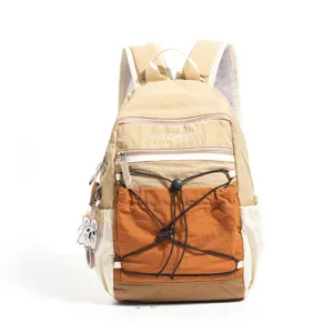 Detailed view of the colorblock casual backpack featuring front elastic cord and zipper pocket.
