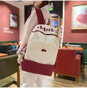 Color block large capacity school backpack with cute letters print for students daily use.