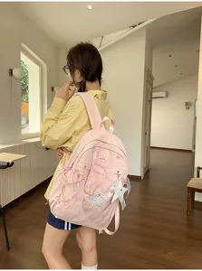 Zaino da studente rosa con tasca frontale trasparente e graziosi ciondoli a stella per la scuola.