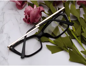 Stylish butterfly eyeglasses frame featuring black resin and elegant gold metal temples.