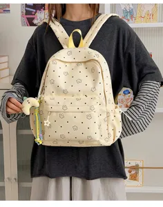 Cute pastel yellow student backpack with star and dot print, perfect for school and daily use.
