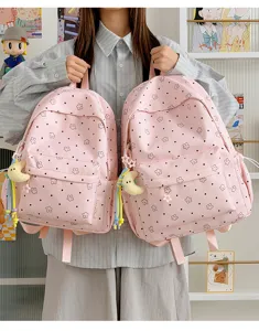 Pink star print nylon school backpack casual daypack for student daily use with cute moon charm.