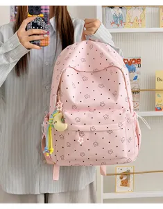 Pink nylon student school backpack with cute star and dot pattern, large capacity casual daypack for girls.