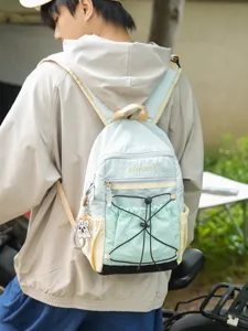 Casual colorblock backpack for outdoor travel, stylish dual-shoulder daypack with front mesh pocket.