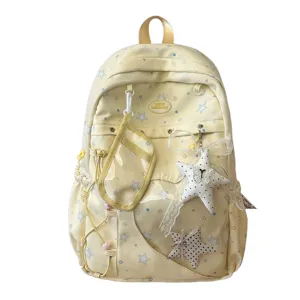 Detalle de mochila escolar de lona con estrellas y bolsillo frontal transparente con bonitos colgantes.