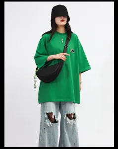 Detailed view of the trendy nylon crescent crossbody bag worn by model, casual style.