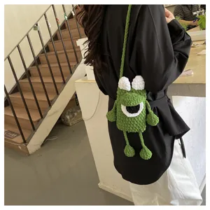 Cute green crochet monster crossbody bag for women, handmade cartoon knitted phone pouch.