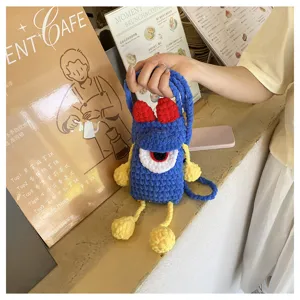Handmade crochet cute blue monster phone bag, vibrant color-blocking crossbody shoulder bag.