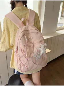 Zaino scolastico rosa carino con tasca trasparente e ciondolo a stella per ragazze adolescenti.