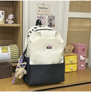 Large capacity color block school backpack with letter print and cute bear pendant for students.