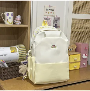 Large capacity canvas school backpack with stylish color block design and cute letter patch.
