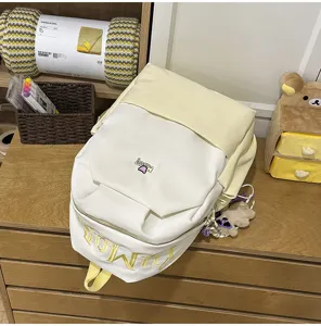Color-blocking student backpack detail, large capacity canvas school bag with embroidery.