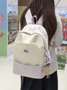 Large capacity student school backpack with cute letter embroidery and chic color blocking design.
