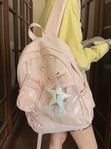 Zaino scolastico rosa di grande capacità con tasca frontale trasparente e ciondolo a stella.