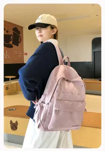 Japanischer minimalistischer rosafarbener Rucksack fuer Maedchen mit suessem Schleifendesign.
