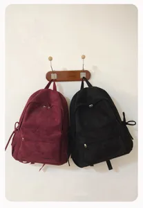 Detailaufnahme des japanischen Schleifen-Rucksacks an der Wand mit Wildleder und Reißverschluss.