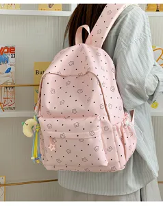 Pink star pattern student school backpack detail view featuring cute hanging charm and pockets