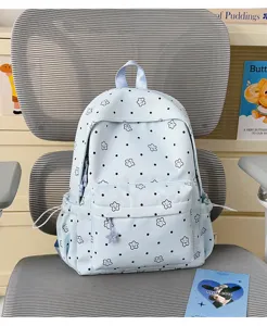 Light blue nylon school backpack with cute star patterns and pockets for students.