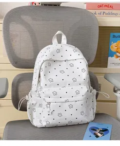 White nylon student backpack with cute black dots and smiling stars for daily school use.