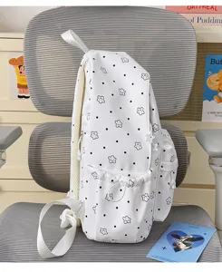 White nylon student backpack detail, cute star and dot pattern, spacious daily school bag.