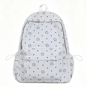 White student backpack detail showcasing cute star prints, black dots and front pocket.