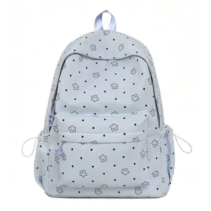 Detailed front view of light blue nylon student backpack with cute smiling stars and dots pattern.