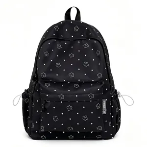 Black nylon school backpack detail, cute star polka dot pattern, front pocket and side pockets.