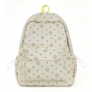 Cute star dot patterned nylon backpack detail, featuring front zip pocket and sturdy yellow handle.