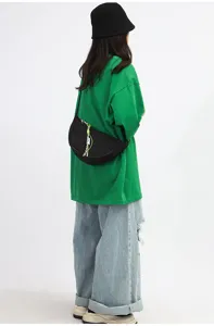 Black nylon crescent crossbody bag, minimalist casual shoulder bag for daily commuting style.