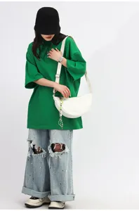 White crescent crossbody bag detail view, minimalist nylon dumpling shoulder bag for women.