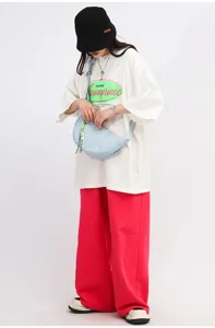 Woven nylon crossbody dumpling bag for women, stylish casual shoulder bag with cute charm.