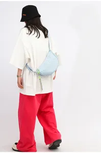 Light blue nylon woven crescent crossbody bag, casual stylish dumpling shoulder bag for daily wear.