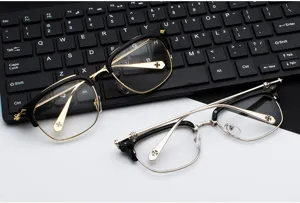 Metal frame optical glasses detail showing exquisite carved temple design and classic cross decor.