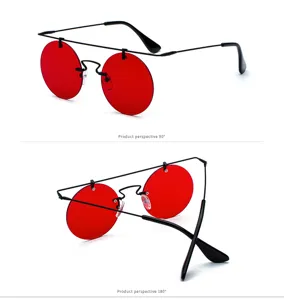 Lunettes de soleil rondes vintage avec verres rouges et fine monture noire tendance.