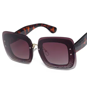 Oversized square sunglasses for women with gradient glitter lenses and tortoiseshell temples stylish eyewear.