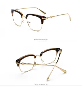 Detail view of stylish half-frame metal optical glasses with tortoise brow line and carvings.
