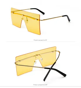 Vista detallada de gafas de sol oversize de pantalla plana con lentes amarillas y varillas.