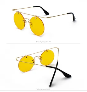 Lunettes de soleil rondes rétro avec monture en métal doré et verres jaunes tendance.