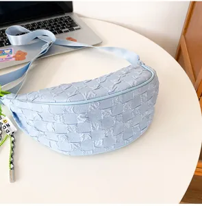 Light blue pleated nylon dumpling bag detail, featuring unique grid texture and stylish strap.