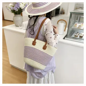 Detailed scene shot of a stylish straw tote bag with purple stripes and brown handles.