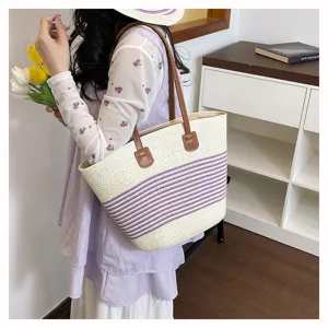 Detailed view of the woven stripe tote bag showcasing texture, purple pattern and brown handle.