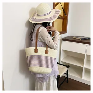 Stylish straw woven tote bag with purple stripes and brown handles for women beach summer vacation.