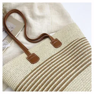 Woven straw tote bag for women, stylish striped shoulder bag and casual beach handbag detail.
