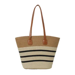 Woven straw tote bag featuring contrast color stripes and comfortable brown shoulder handles.